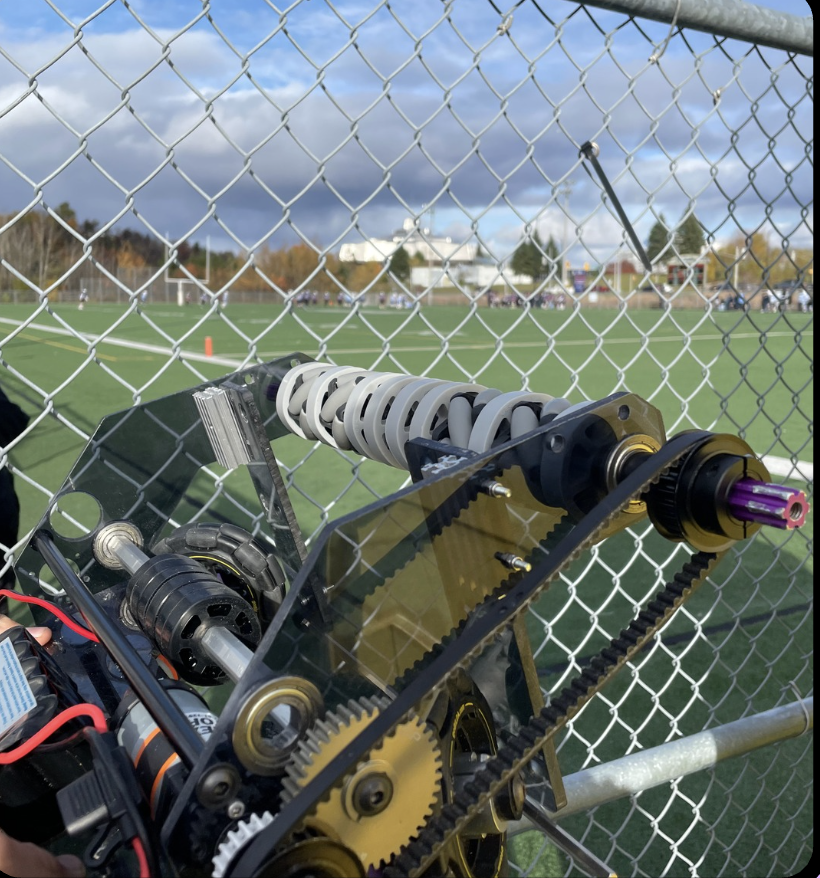 Team Purple robot mechanism at an outreach event