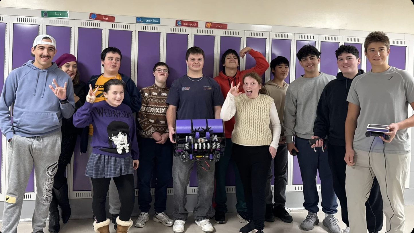 Team Purple full team photo with robot at school